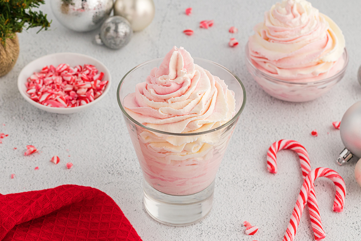 angled shot of glass of pink whipped cream