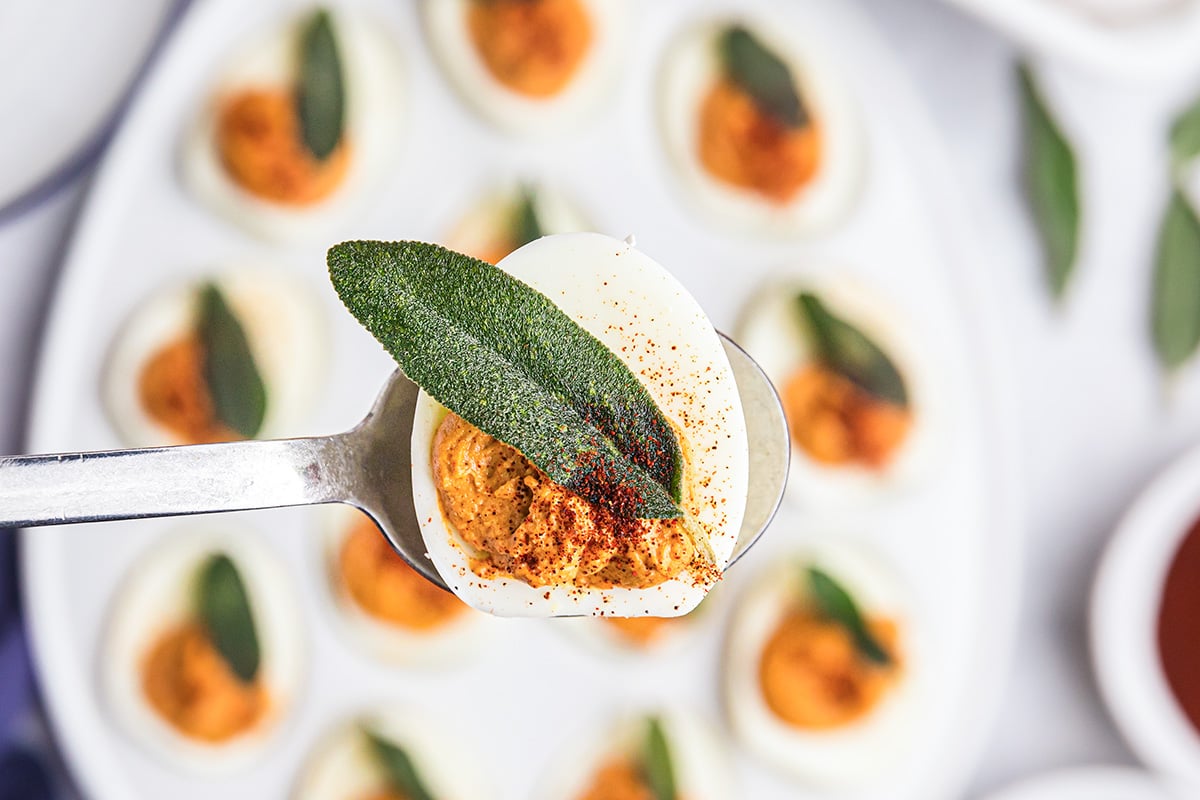 overhead shot of pumpkin deviled egg on a spoon