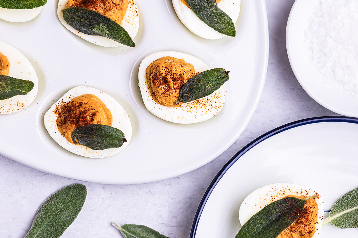 close up over head shot of pumpkin deviled eggs on platter