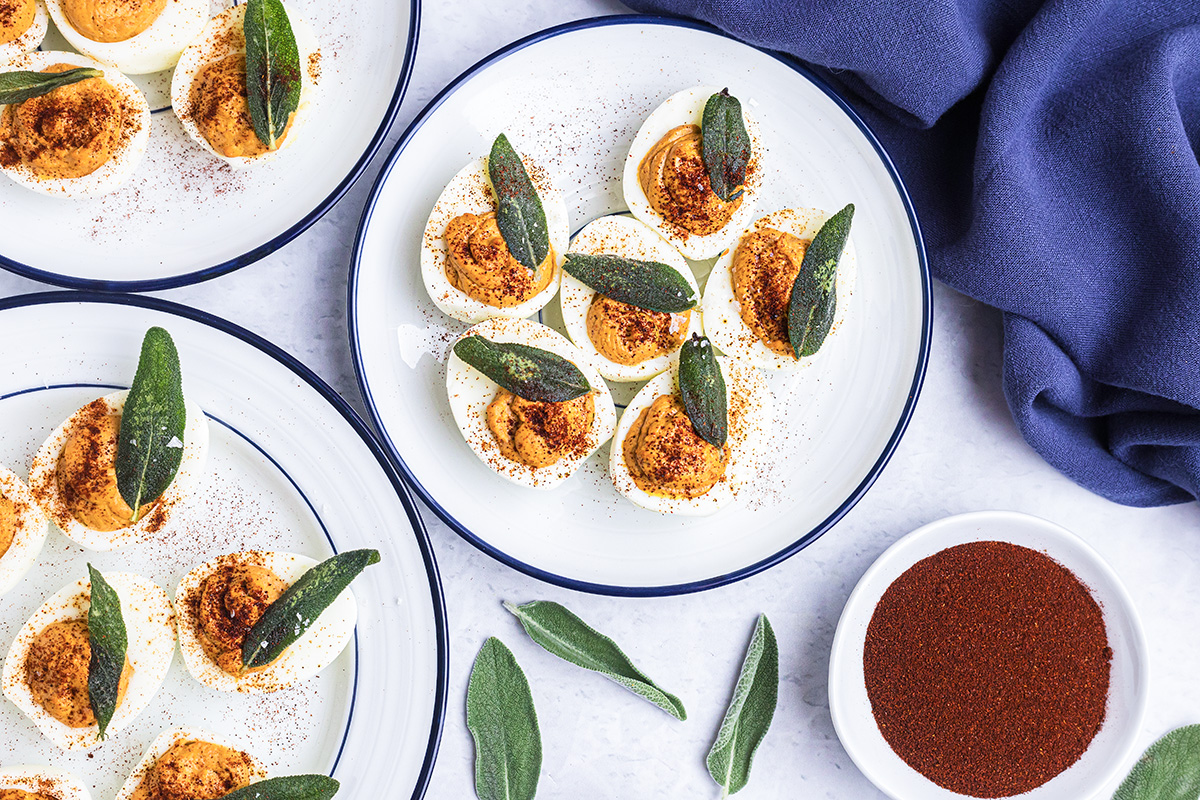 overhead shot of plate of pumpkin deviled eggs