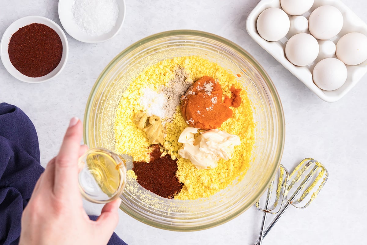 pumpkin deviled egg filling ingredients in bowl