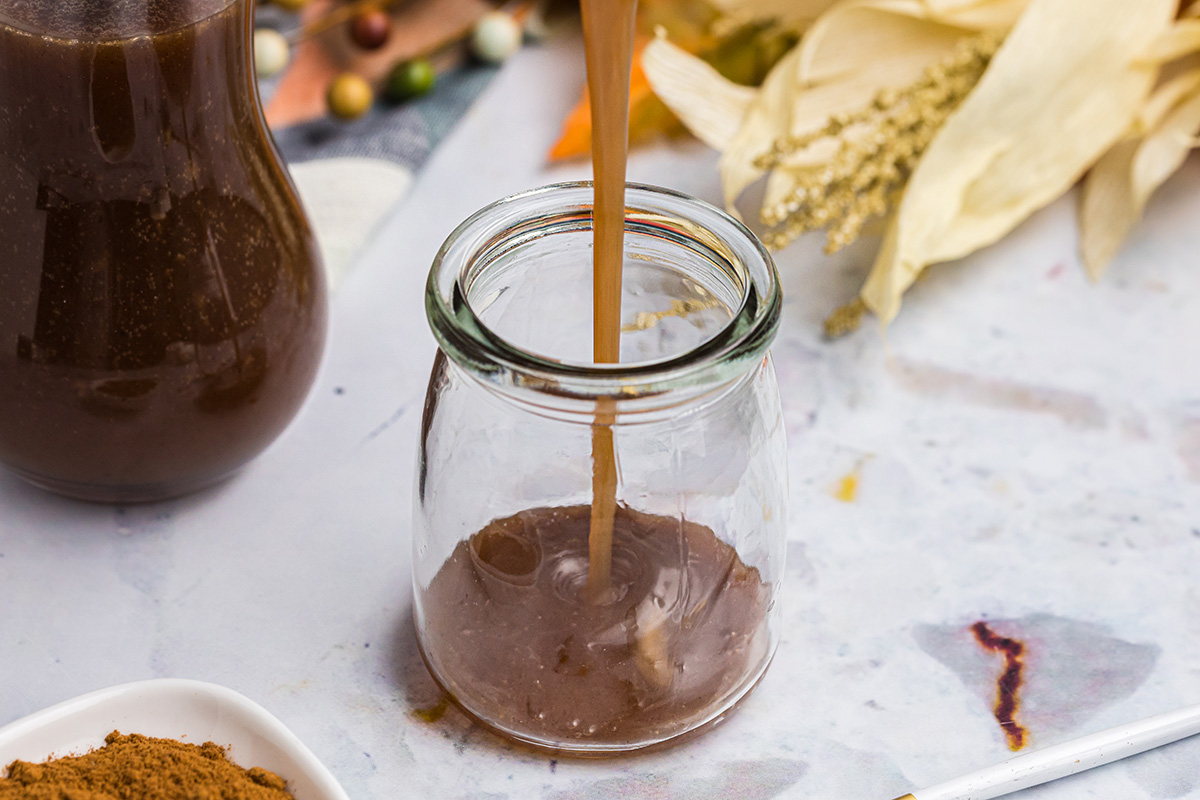 angled shot of pumpkin spice syrup poured into jar