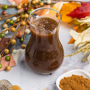 angled shot of pitcher of pumpkin spice syrup