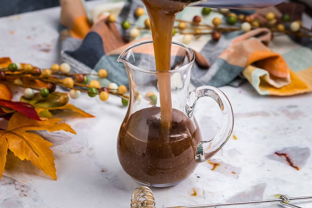 straight on shot of pumpkin spice syrup into jar