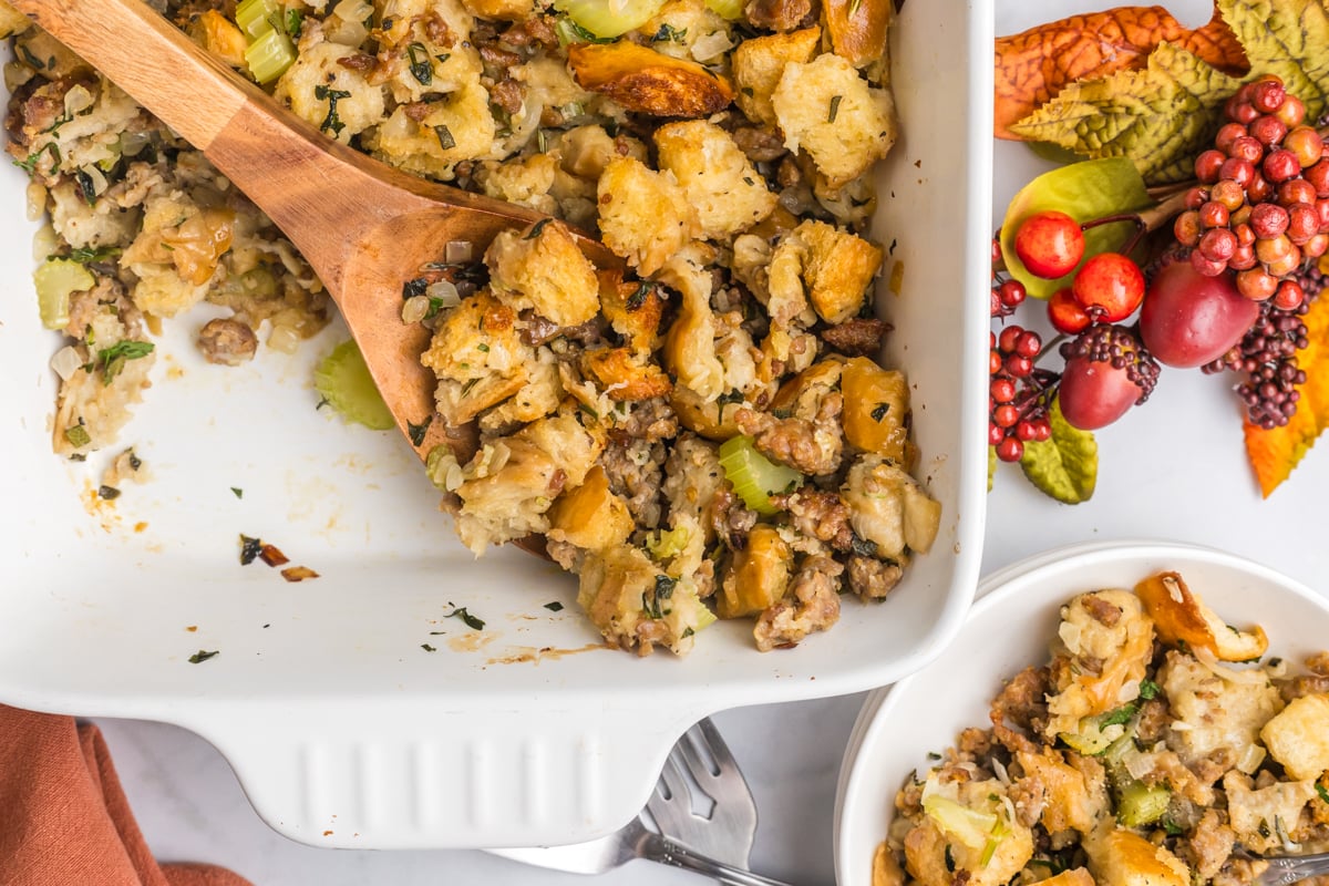 overhead shot of wooden spoon in dish of sausage stuffing