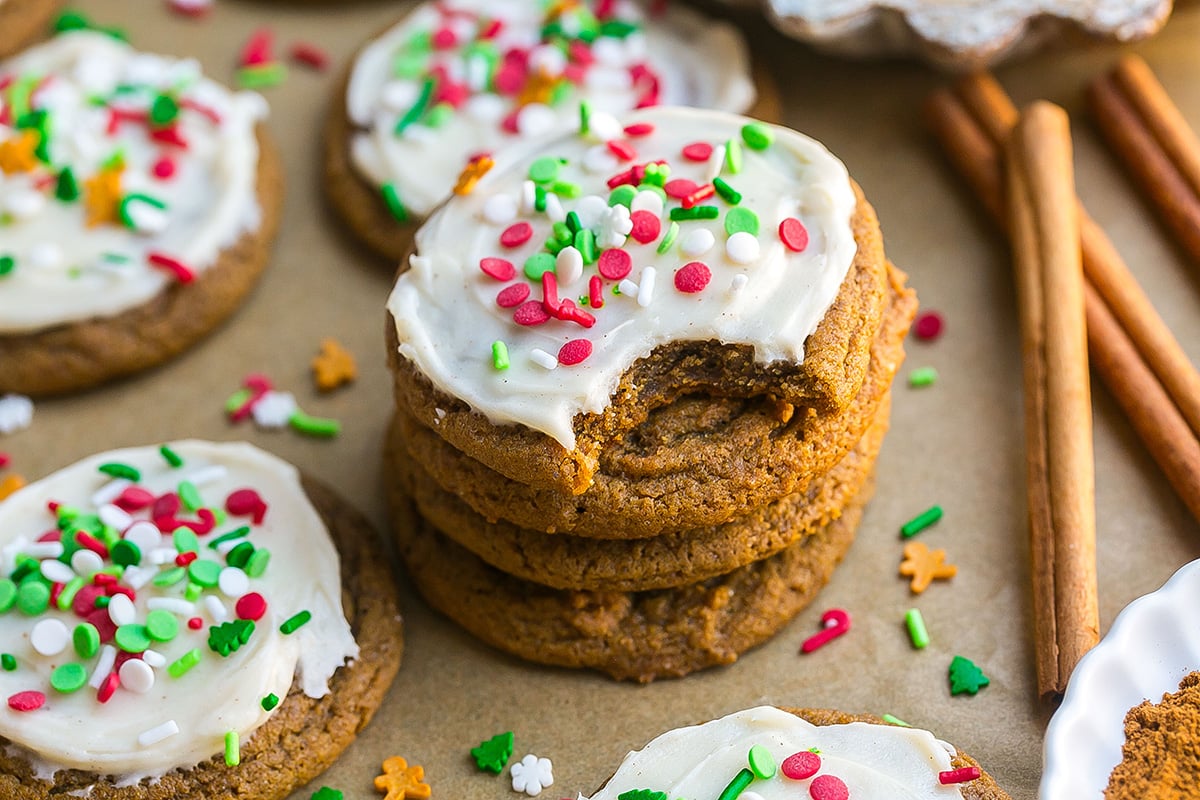 bite taken out of stack of frosted gingerbread cookies