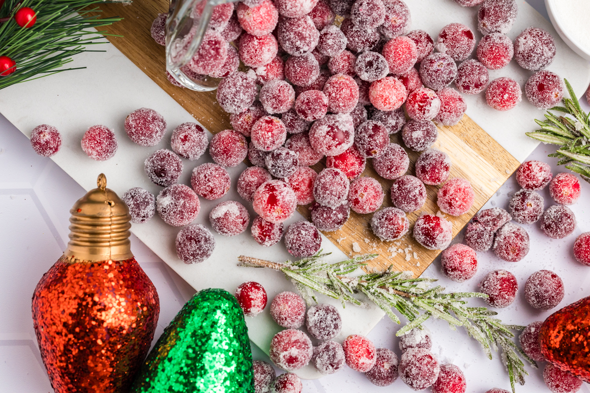 overhead shot of cranberries spilled over a wooden board