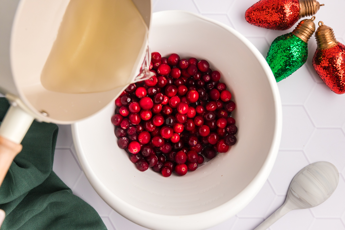 simple syrup poured over bowl of cranberries