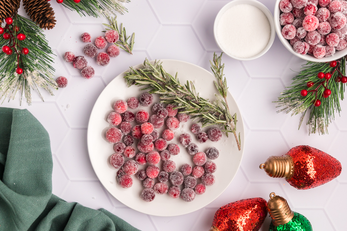 overhead shot of plate of sugared cranberries with rosemary