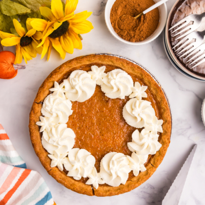 overhead shot of whipped cream on sweet potato pie