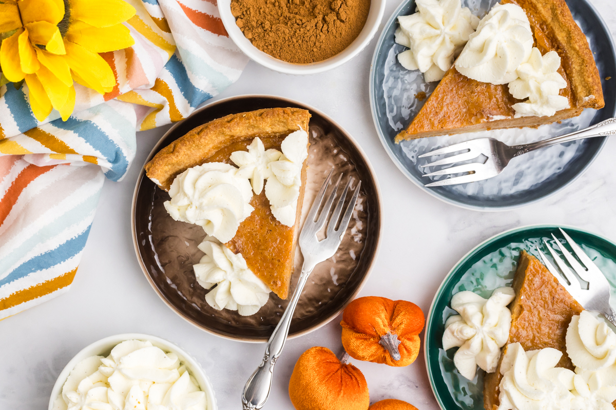 overhead shot of slices of pie on plates with forks