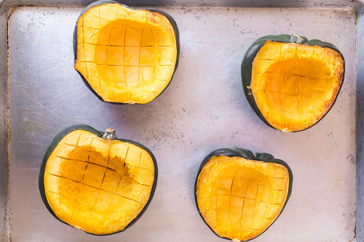 four scored acorn squash