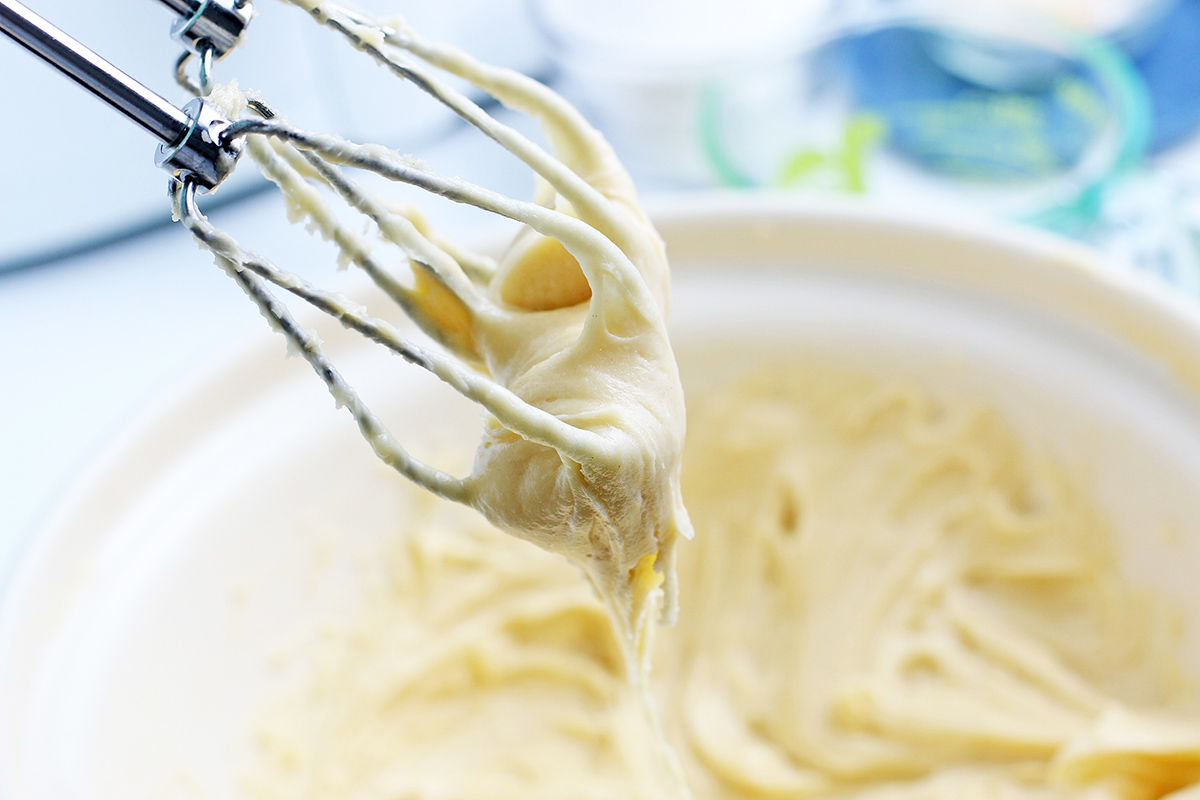 close up of churro dough on mixers