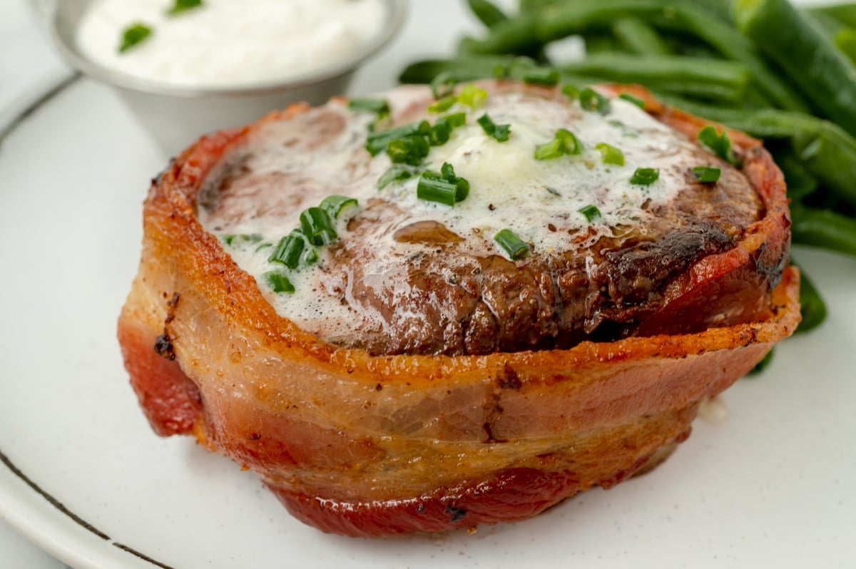 close up angled host of filet on plate with green beans