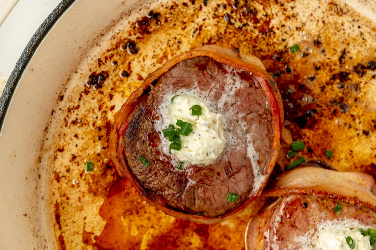 close up overhead shot of bacon wrapped filet in pan