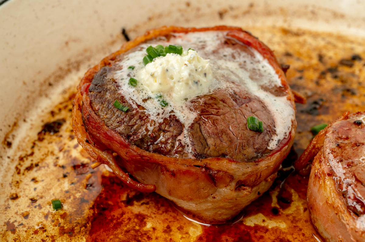 close up angled shot of filet cooking in pan