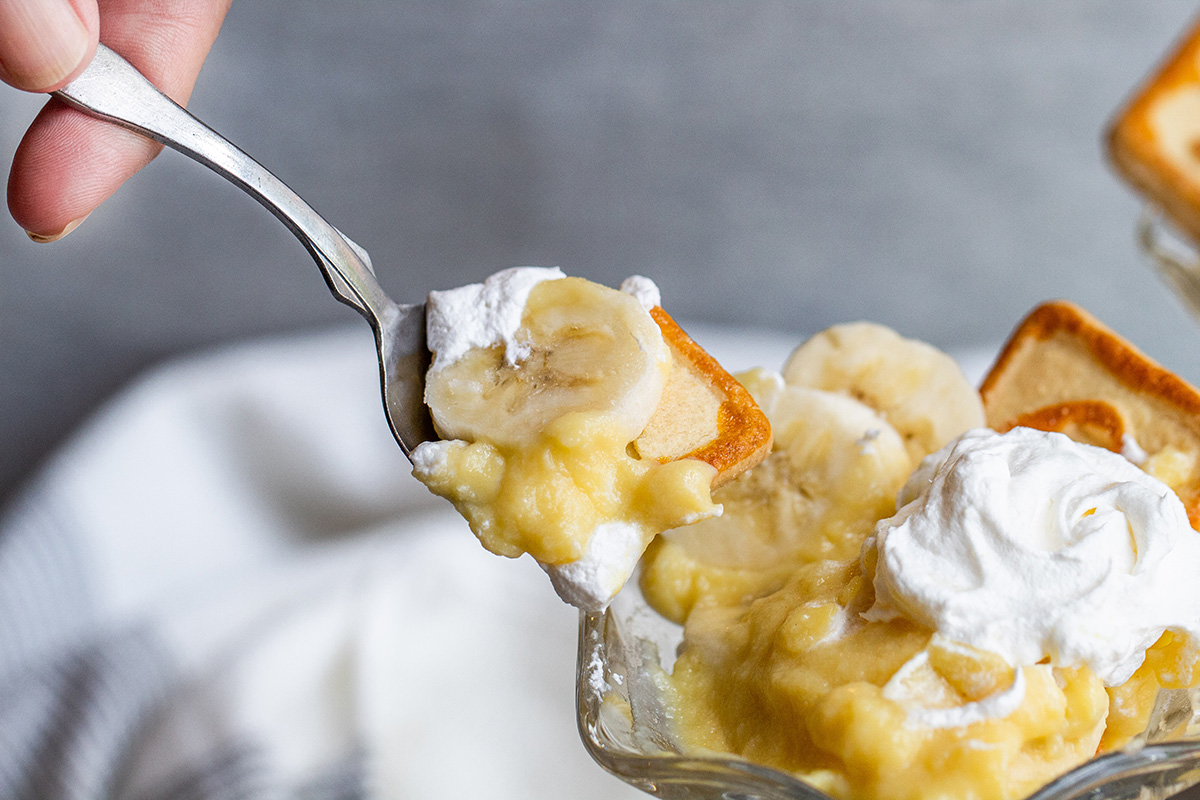 spoon taking bite of banana pudding cup