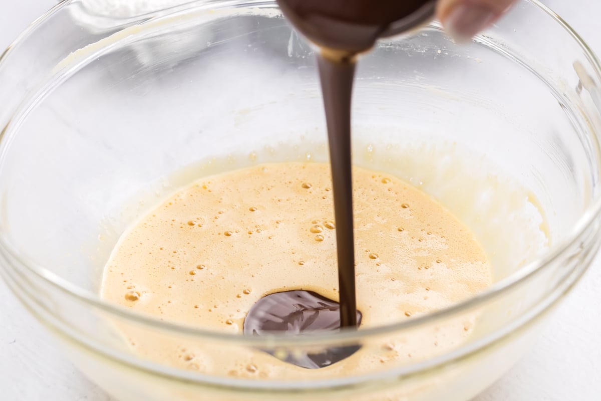 chocolate poured into bowl of frosting ingredients