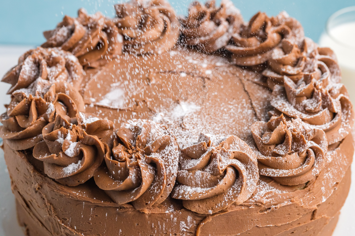 powdered sugar sprinkling onto cake