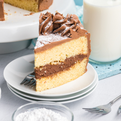 angled shot of slice of brown butter cake on stack of plates