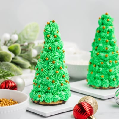 straight on shot of two christmas tree cake cones with gold decorations