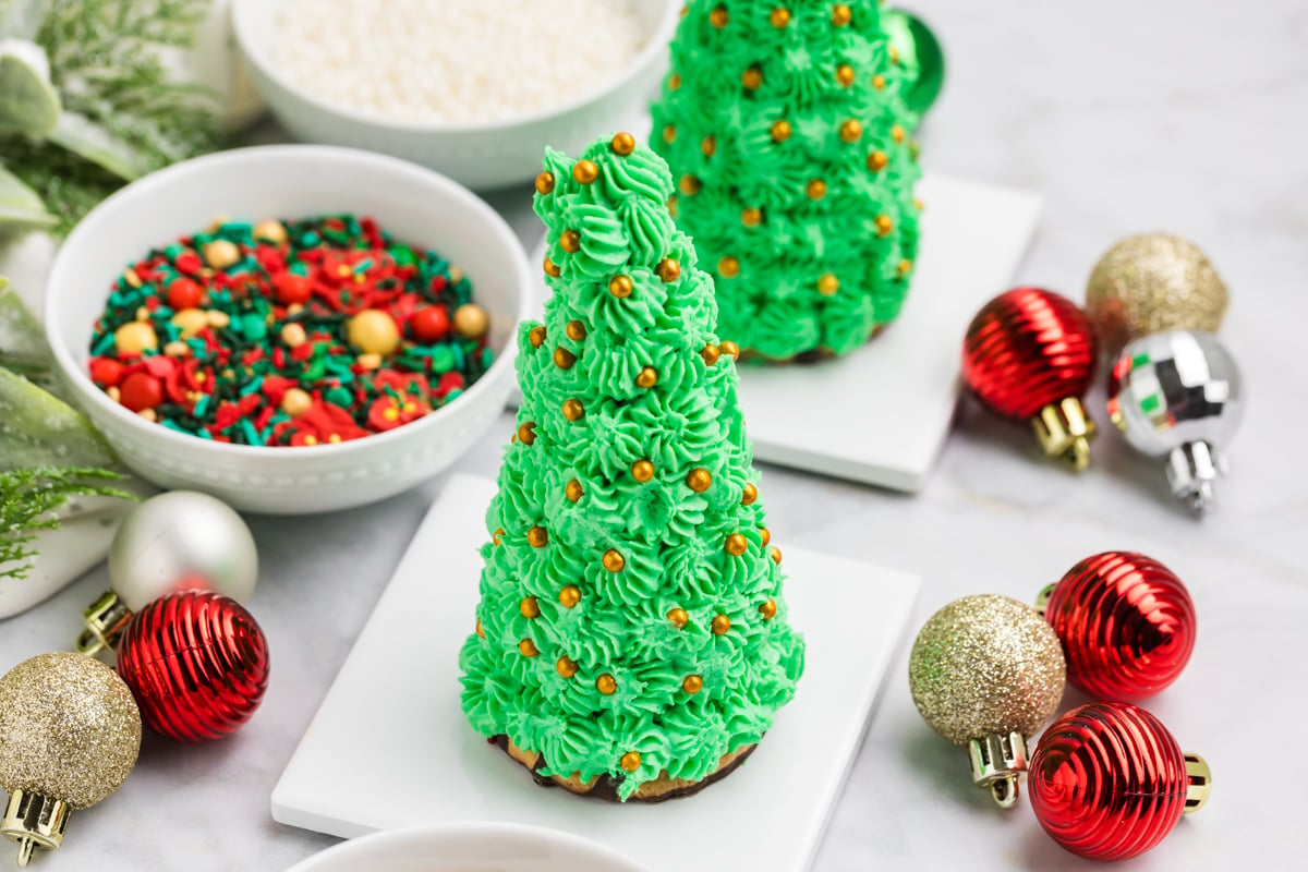 angled shot of christmas tree cake cones with gold decorations