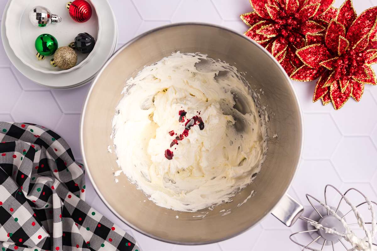 red food coloring added to bowl of frosting