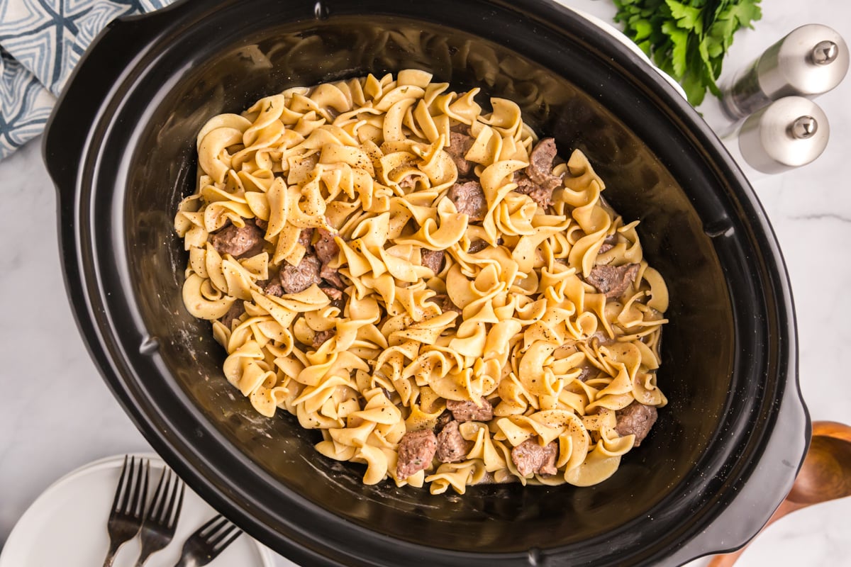 overhead shot of beef and noodles in a crock pot