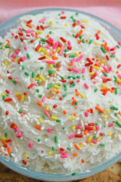 close up angled shot of bowl of funfetti cake batter dip