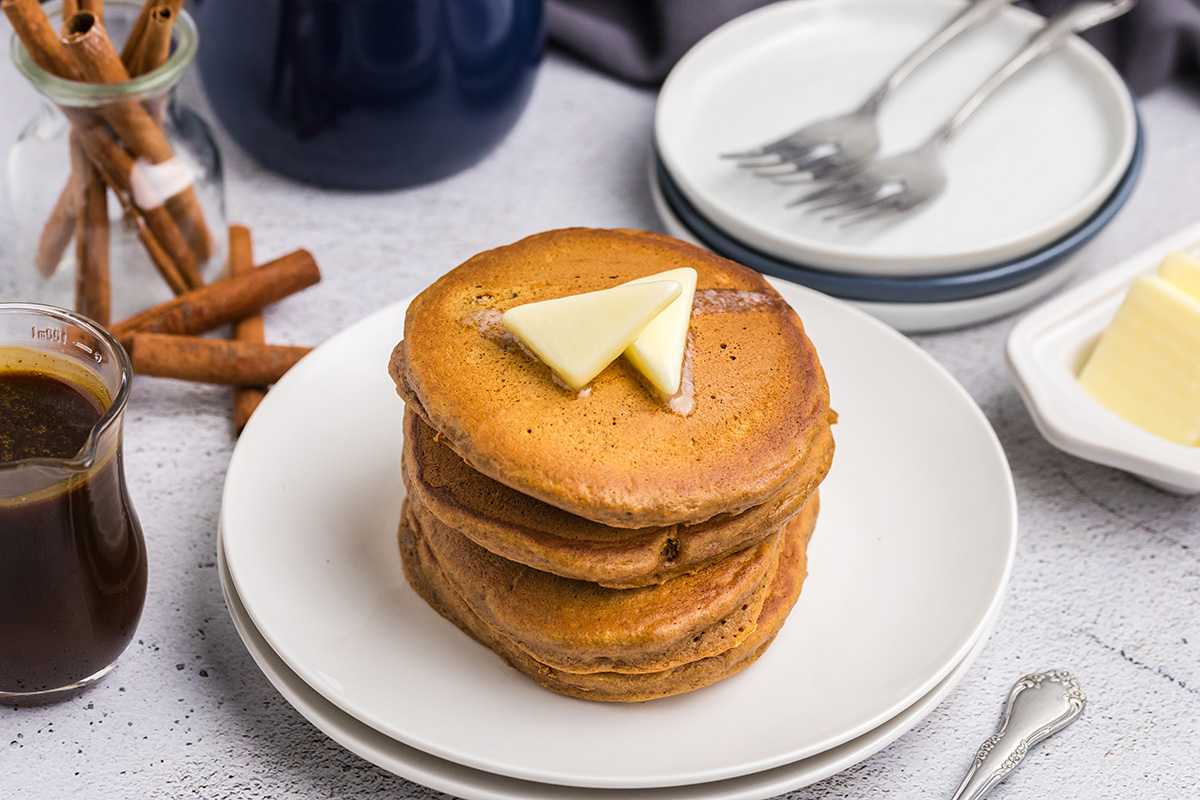 angled shot of stack of gingerbread pancakes topped with butter