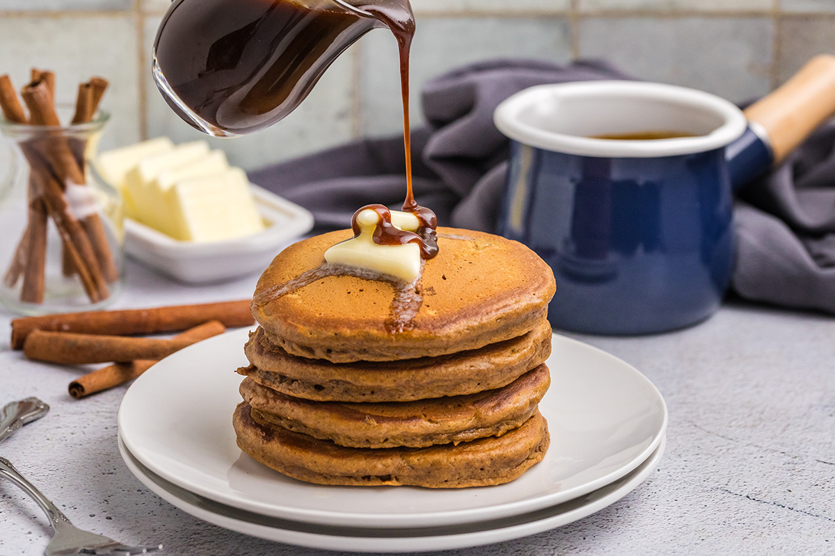 straight on shot of syrup poured oven stack of gingerbread pancakes