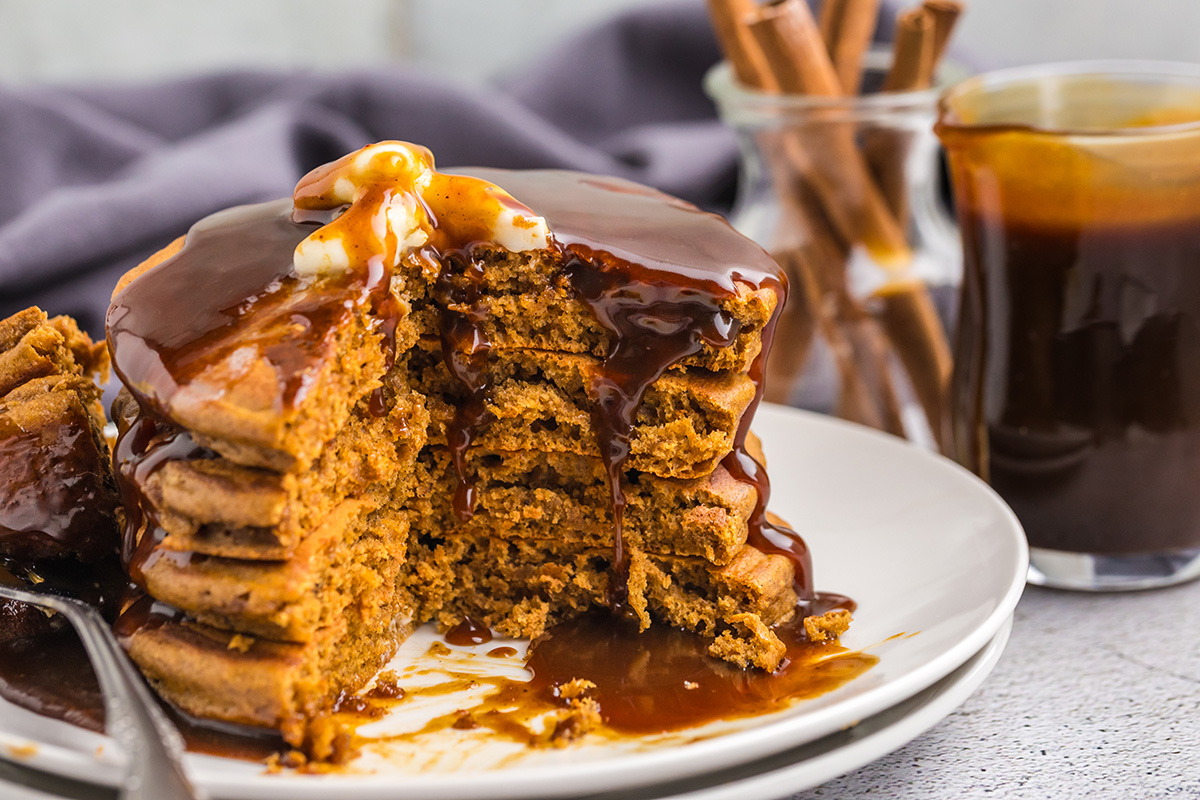 close up of stack of gingerbread pancakes with bites taken out