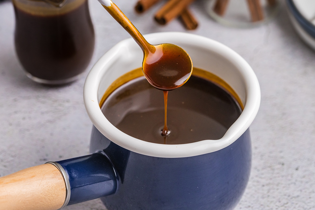 spoon dipping into bowl of gingerbread syrup