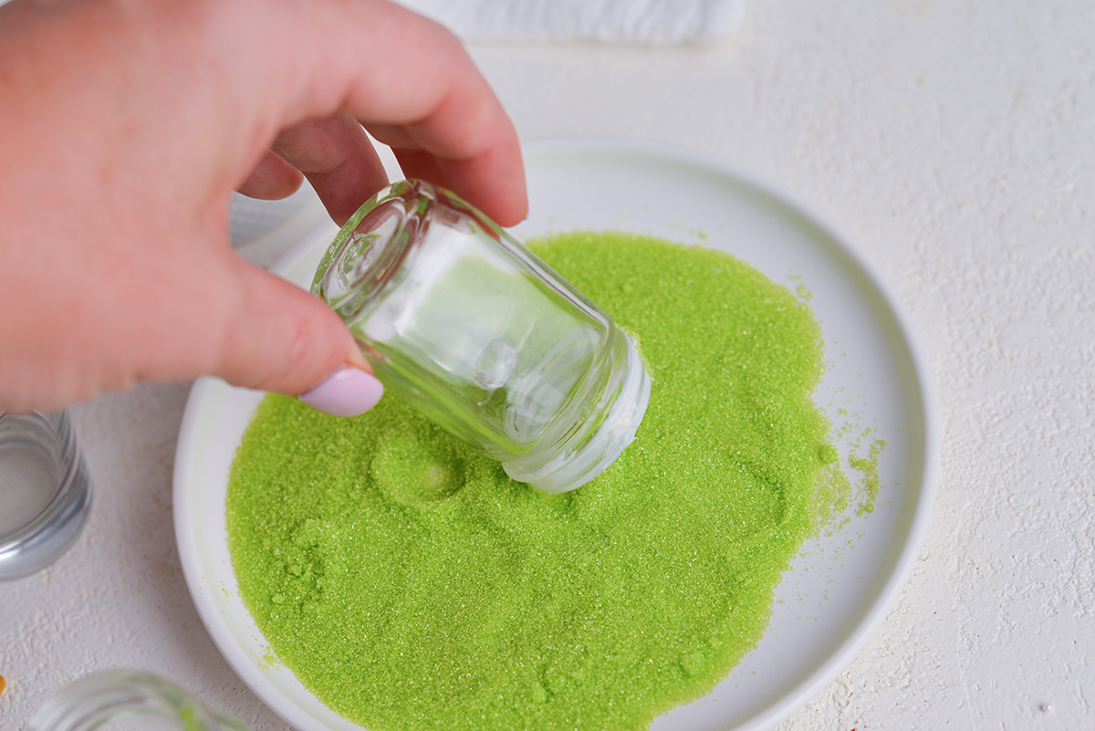 shot glass dipped into green sprinkles