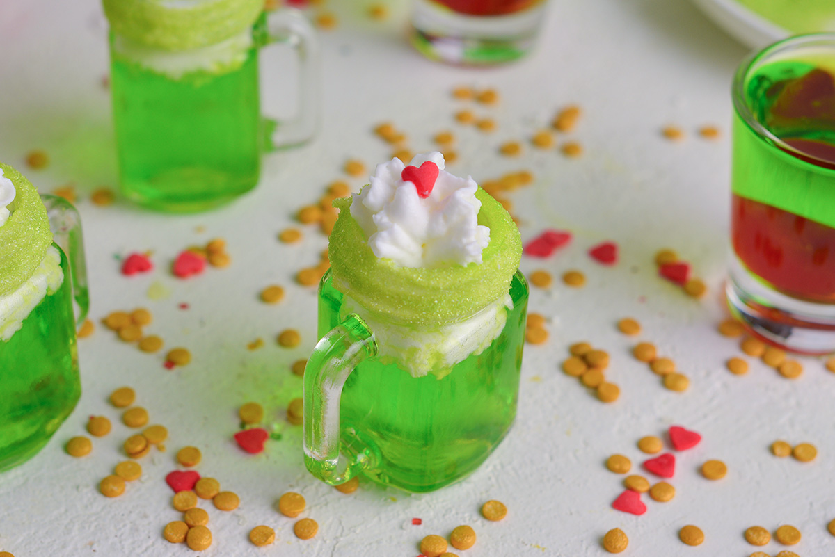 angled shot of grinch shot topped with whipped cream