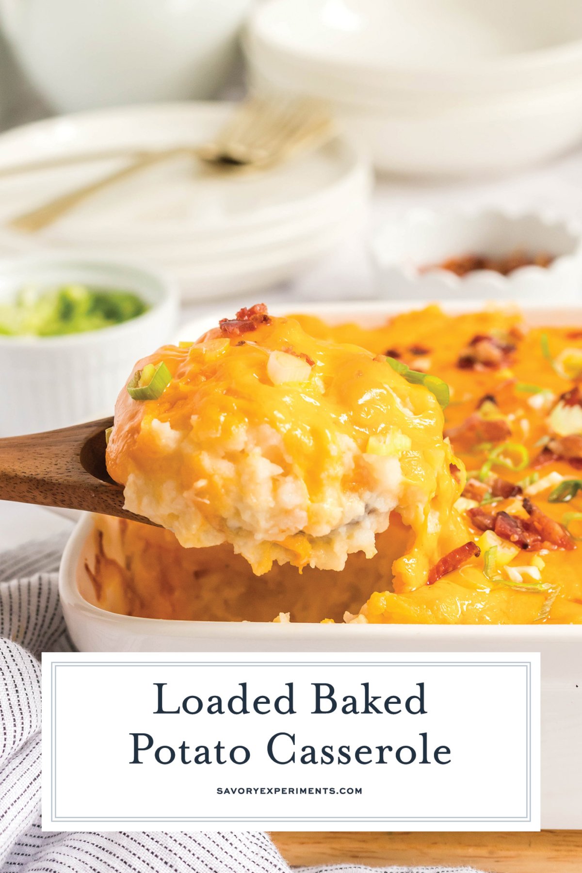 wooden spoon scooping out loaded baked potato casserole with text overlay