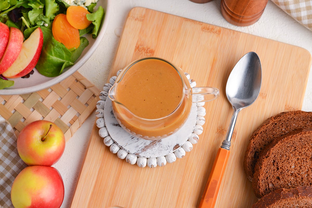 overhead shot of jar of maple dijon dressing with spoon