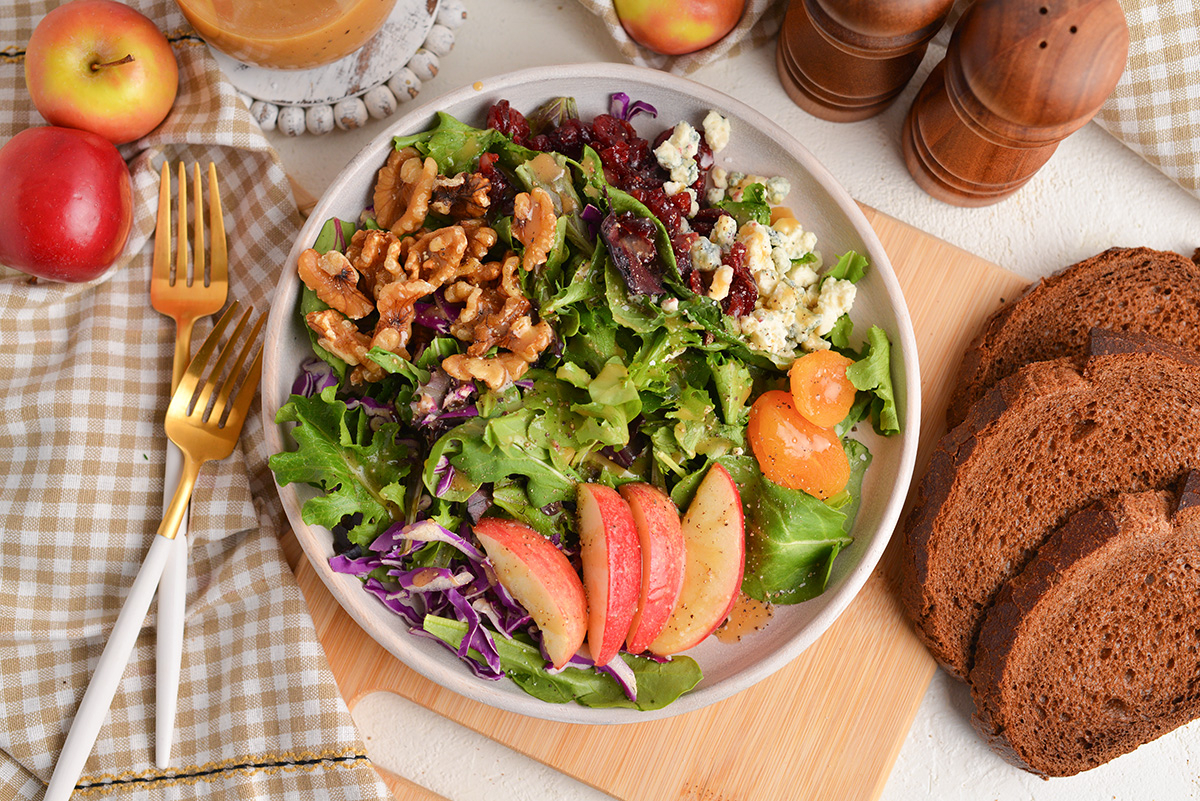 overhead shot of salad with walnuts and apples