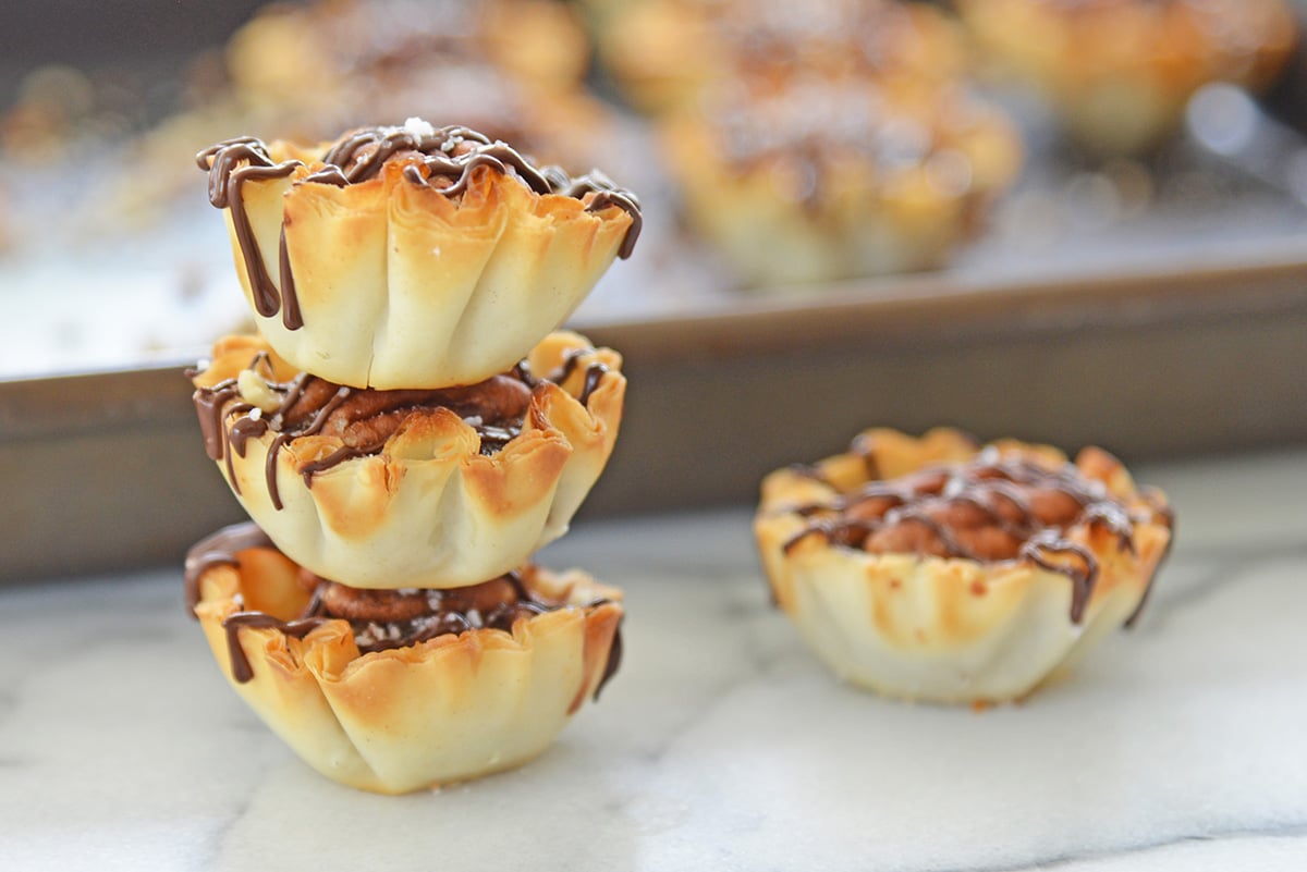 straight on shot of stack of mini pecan pies