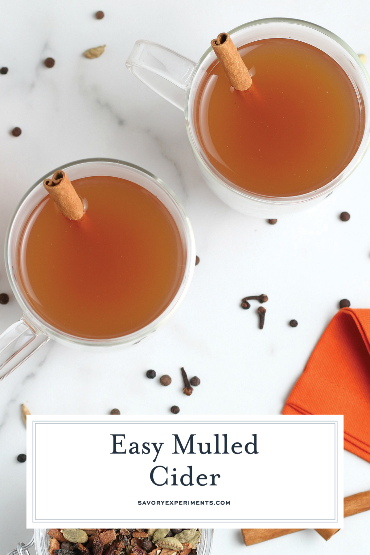 overhead shot of two mugs of mulled cider with text overlay