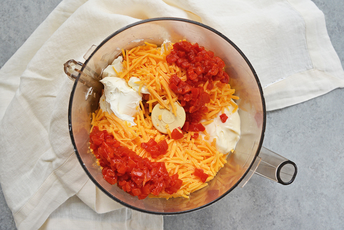 overhead shot of pimento cheese ingredients in food processor