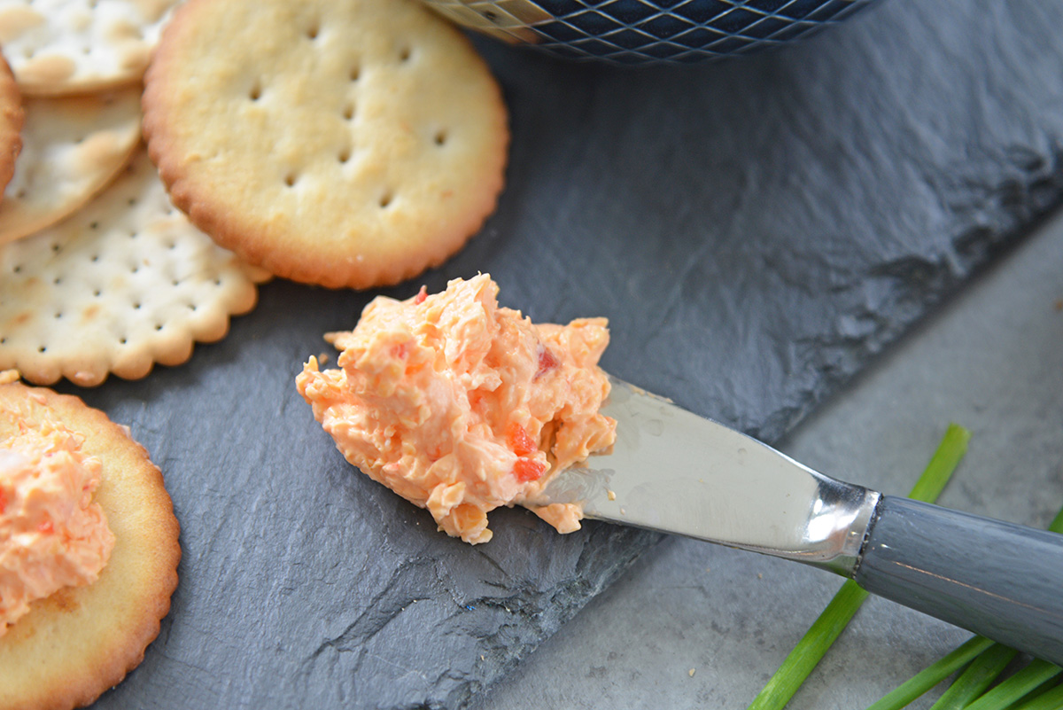 close up of pimento cheese on knife