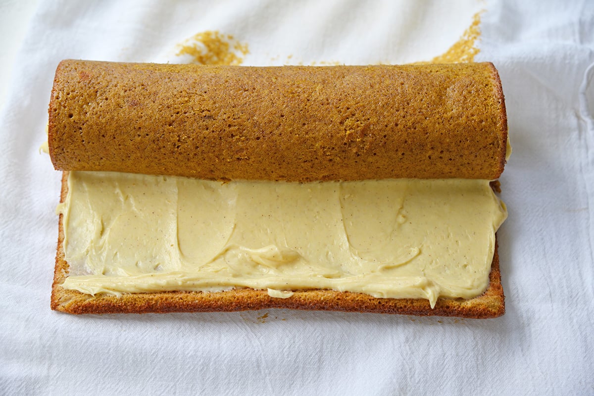 rolling up a pumpkin cake roll