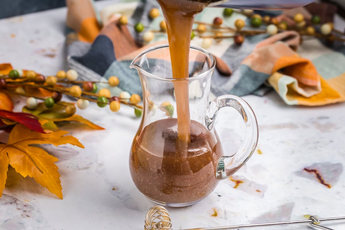 straight on shot of pumpkin spice syrup into jar