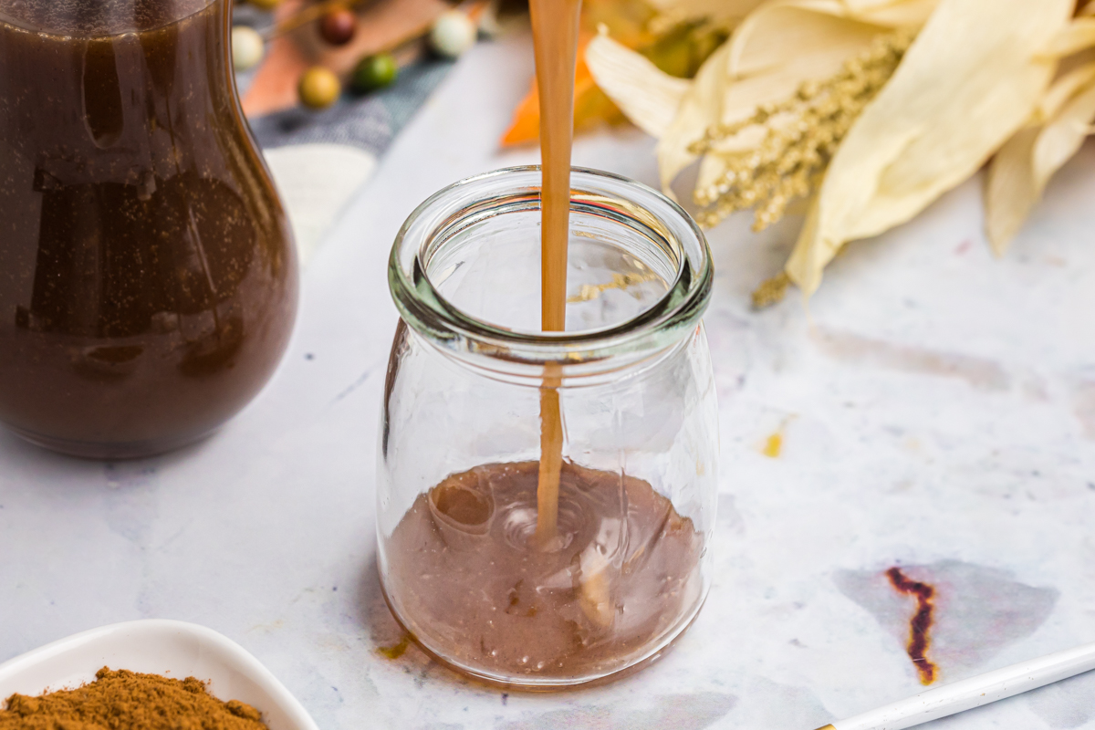 angled shot of pumpkin spice syrup poured into jar