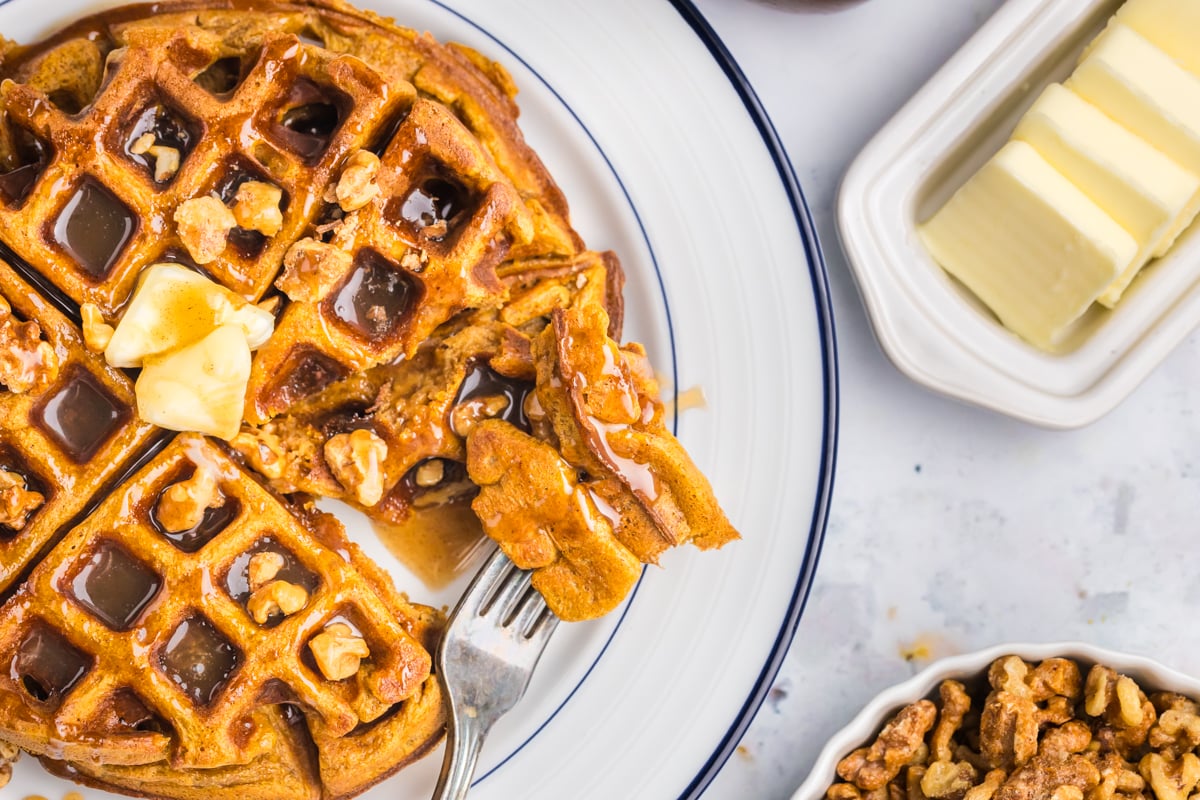 overhead shot of bite of pumpkin waffles on fork