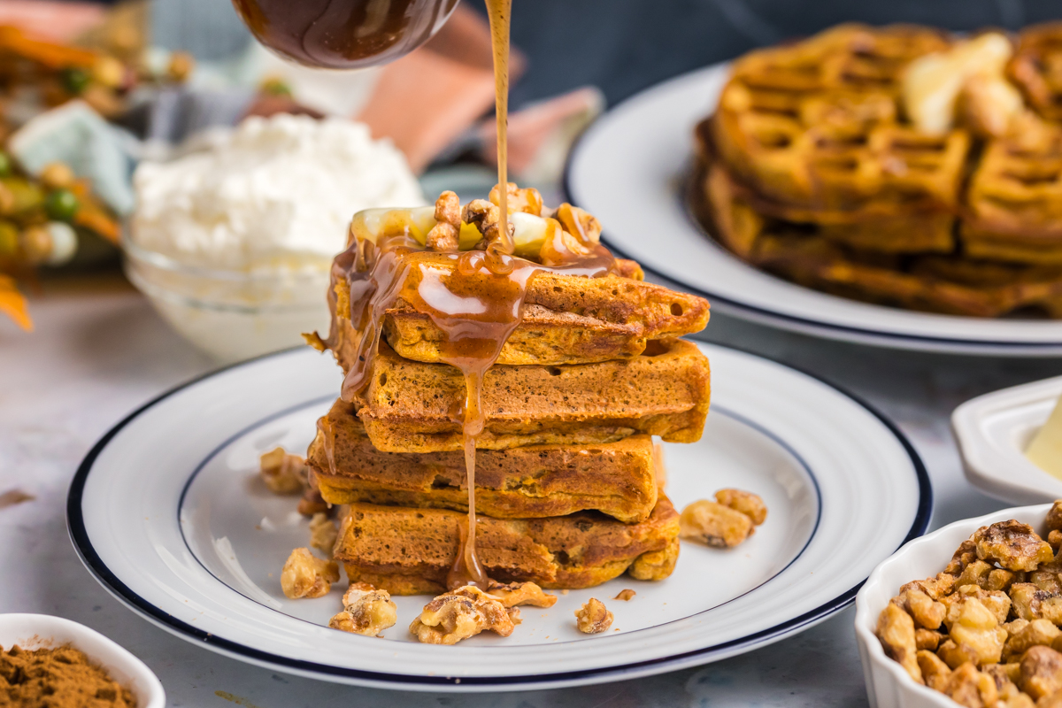 syrup poured over stack of pumpkin waffles