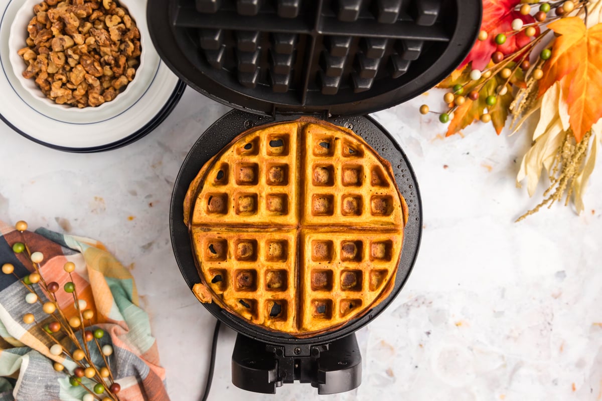 overhead shot of pumpkin waffles on waffle iron