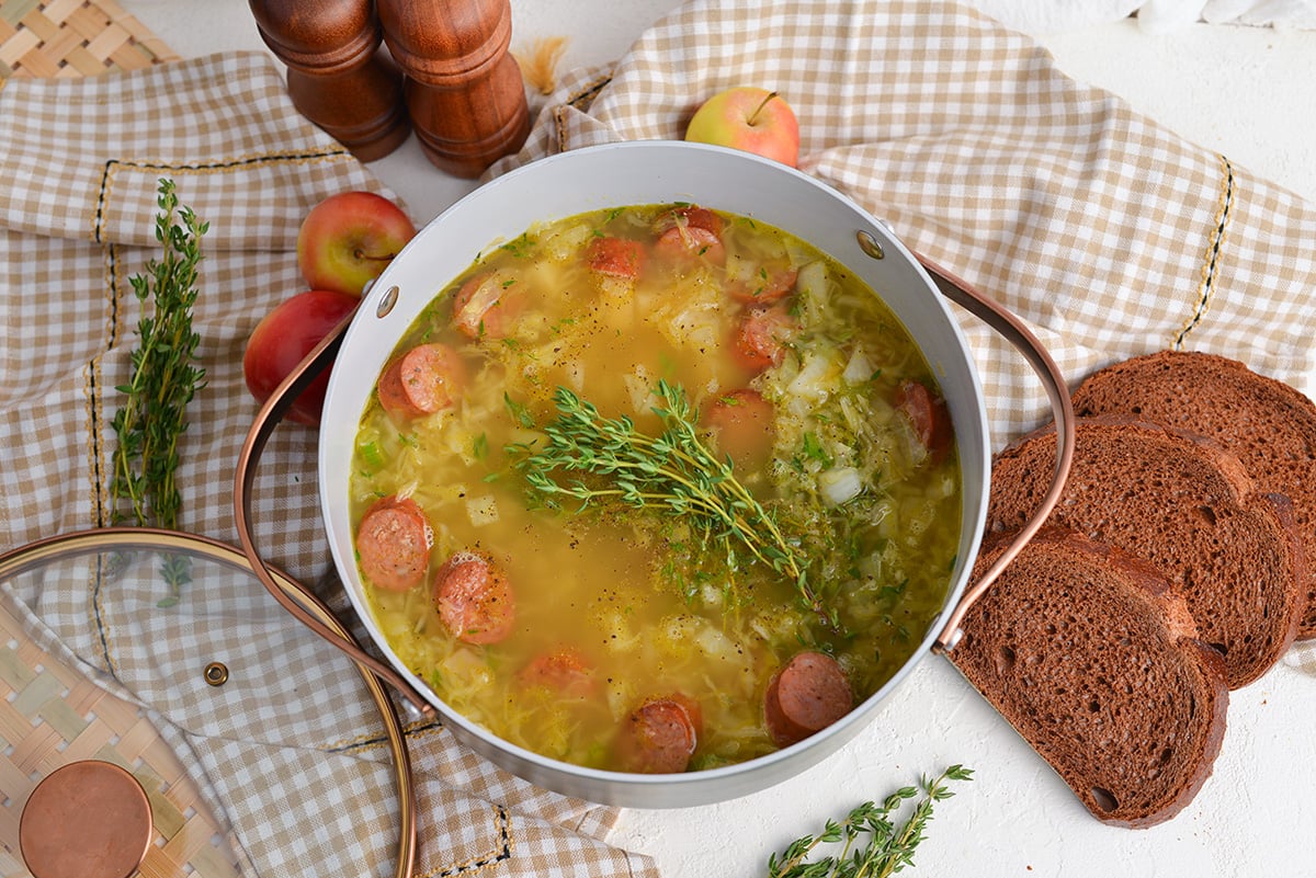 overhead shot of sauerkraut and kielbasa soup in pot