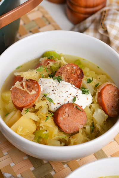 angled shot of bowl of sausage and sauerkraut soup